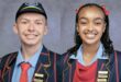 Twee Hoërskool Volksrust-leerders in skooldrag poseer as dubbele Dux.