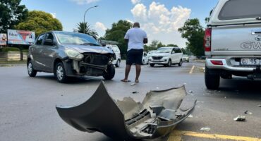Damaged car and pickup truck after crash at city intersection