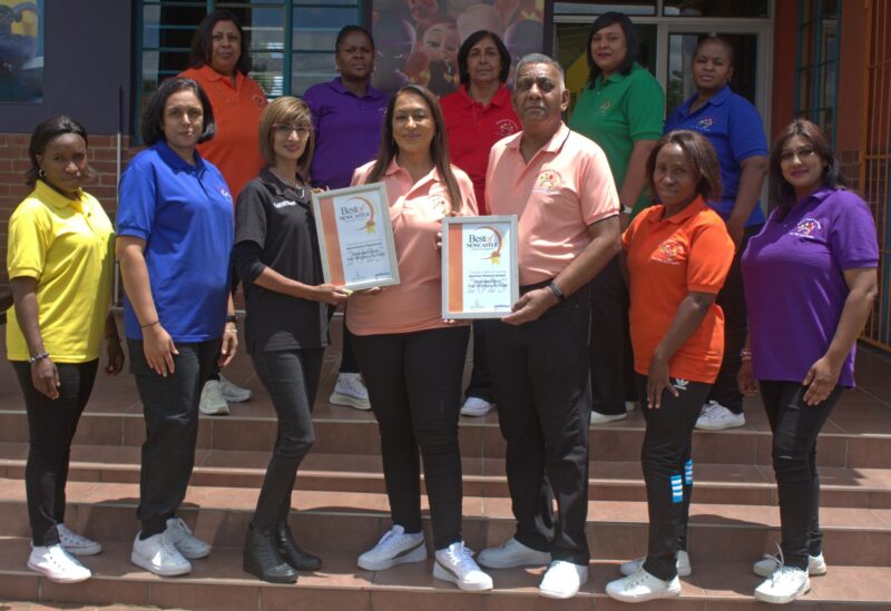 Newcastle Advertiser staff members hand over certificates to a Best of Newcastle Reader's Choice Award winner.