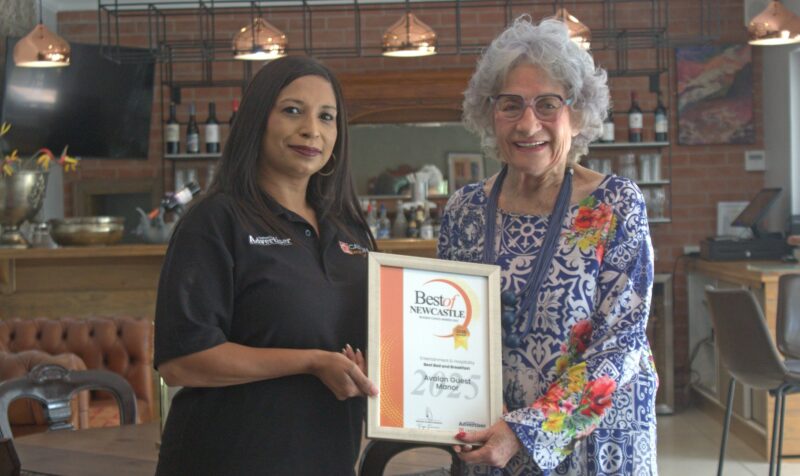 Newcastle Advertiser staff members hand over certificates to a Best of Newcastle Reader's Choice Award winner.