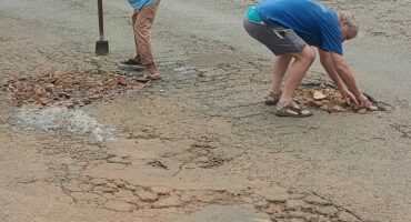 Image of Glencoe residents filling in potholes on the main entrance to the town.
