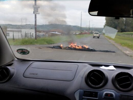 Image of burning tyres on a road.