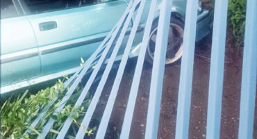 Image of a car hitting a pallisade fencing.
