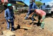 four men are seeing digging into the ground as they fix infrastructure in Utrecht.