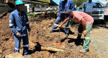 four men are seeing digging into the ground as they fix infrastructure in Utrecht.