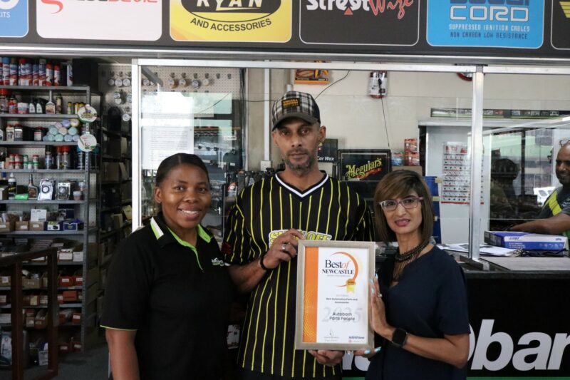Best of Newcastle 2025 Reader's Choice Award winners receiving their certificates from a Newcastle Advertiser representative in their office.
