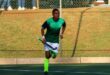 Sphesihle Khaba runs with a hockey stick during a match in his Newcastle High School kit.