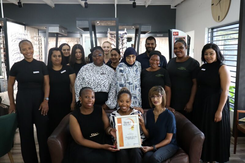 A group of people receiving a certificate from a Caxton Employee.
