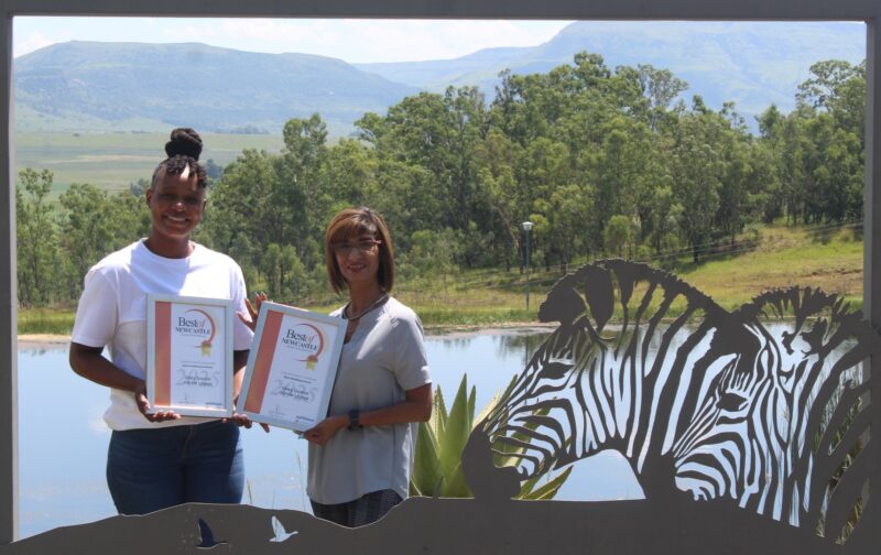 One person receiving a certificate from a Caxton Employee.