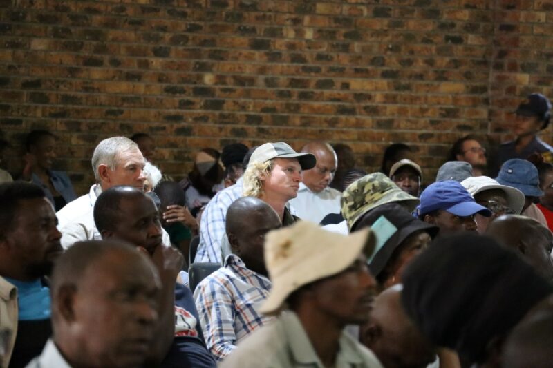 Farmers and community members listen during a foot-and-mouth disease stakeholder meeting.