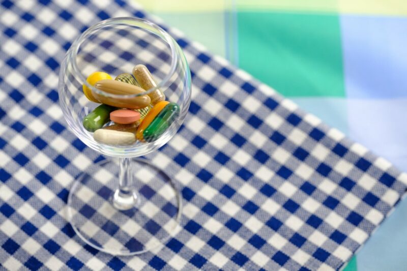 Alt text: Assorted vitamin and collagen capsules in a glass bowl.