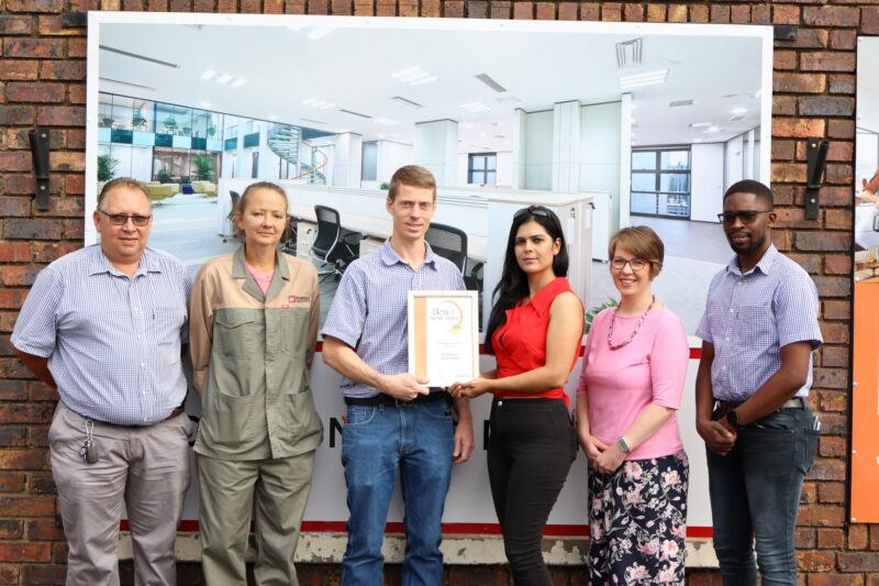 A group of people holding their awards certificate for the Best of Newcastle Readers Choice Awards.