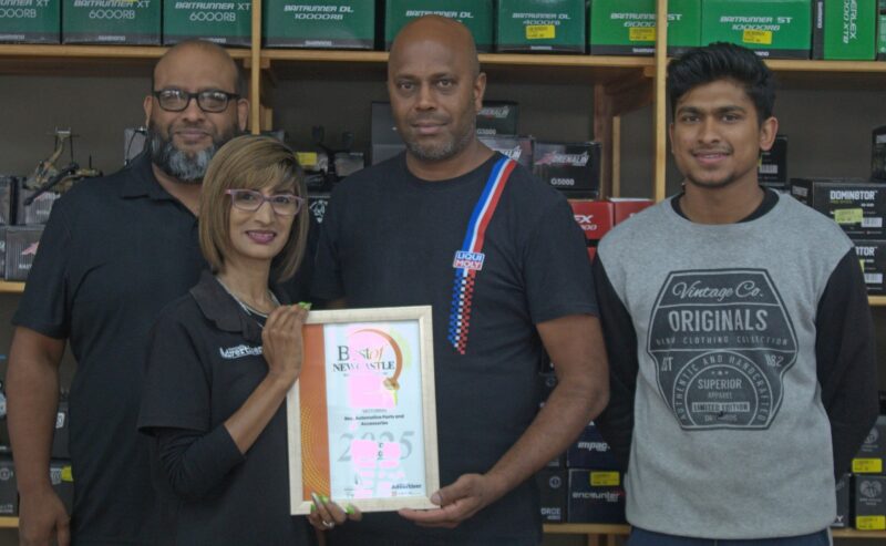 A group of people receiving a certificate from a Caxton Employee.