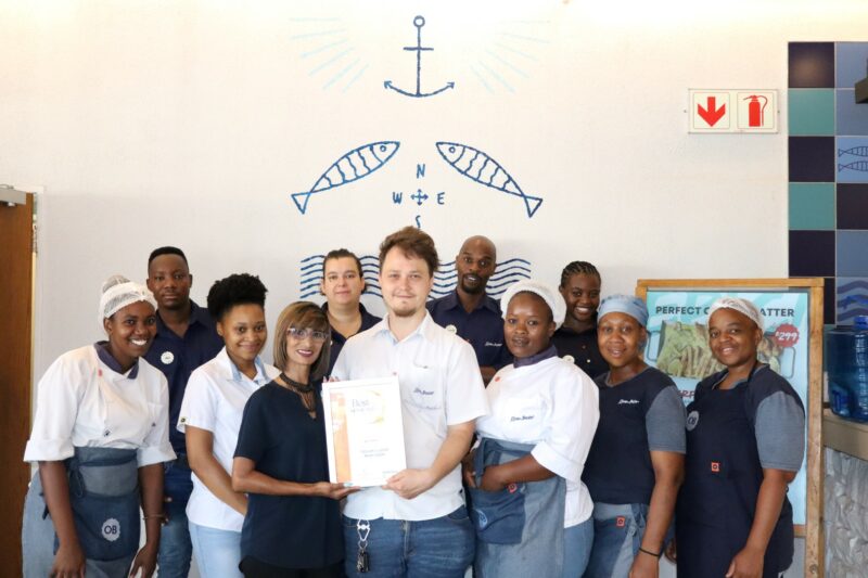 A group of people holding their awards certificate for the Best of Newcastle Readers Choice Awards.