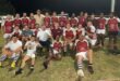 Image of group of adult rugby players dressed in their maroon and white kits.