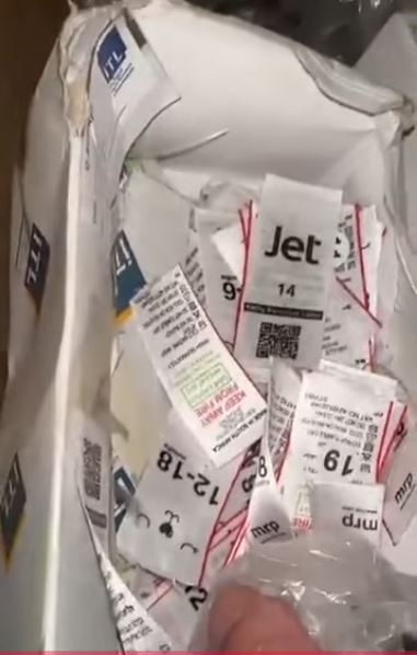 Boxes of tags belonging to a major retailer brand is found at a Chinese Sweat Shop located in Newcastle's Riverside Industrial. (Screen shot from video posted by Juliet Basson).