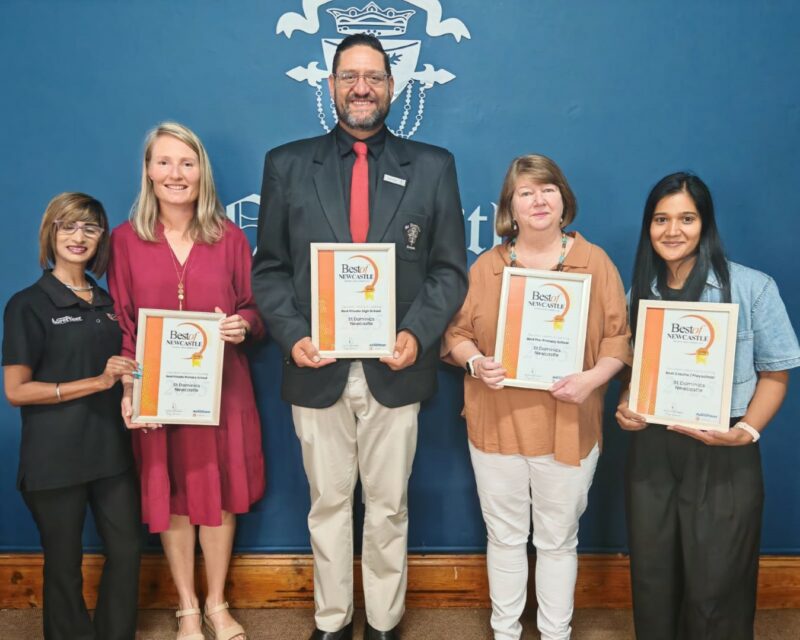 A group of people receiving a certificate from a Caxton Employee.