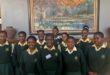 Image of young female learners in yellow and green school uniform from Vryheid High School.
