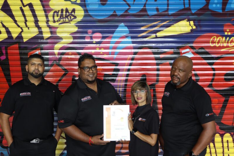 Best of Newcastle 2025 Reader's Choice Award winners receiving their certificates from a Newcastle Advertiser representative in their office.