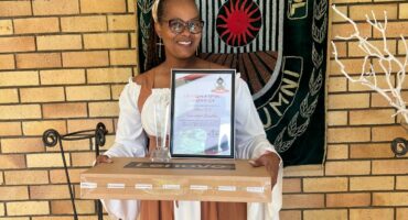 An image of Mrs Nkosi from Landbou High School holding her certificate, trophy and laptop she received as a special recognition, her matric class of 2025 produced the highest Mathematics results in the Filidi circuit