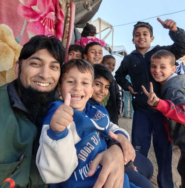 Mahomed Zahir Haniff is photographed with many children living in Gaza.