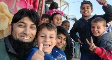 Mahomed Zahir Haniff is photographed with many children living in Gaza.