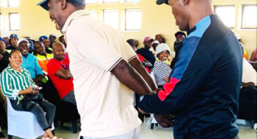 Image of a policeman demonstrating how to use handcuffs.