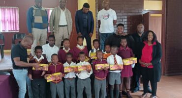 Image of Glencoe school children receiving a donation of shoes.
