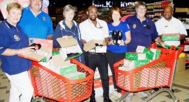 Image of Dundee Rotary Club members receiving school shoes from Dundee SPAR staff.