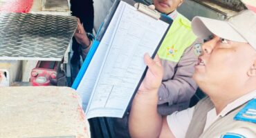 Image of traffic officers checking scholar transport vehicles in Dundee.