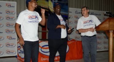 Image of Orange Grove Dairy marking 99 years with entertainer Lucky Mathambo on stage with Orange Grove's Jabulani Khanyile and Dave Durham
