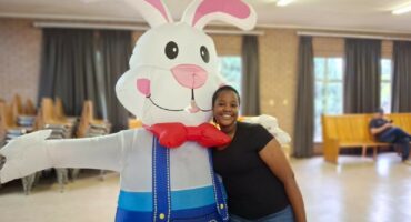 Image of a girl standing with a easter bunny.