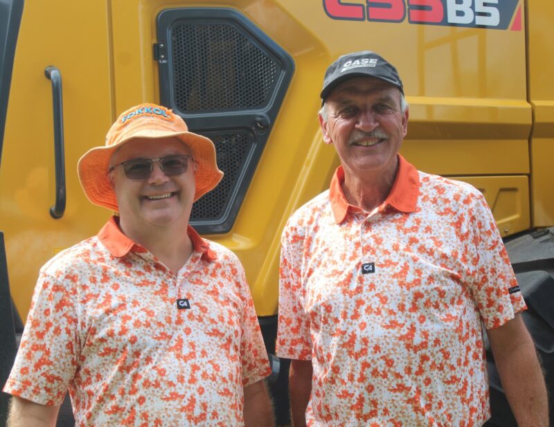 Two golfers posing for a photo at the Newcastle Golf Club wearing their golfing attire.