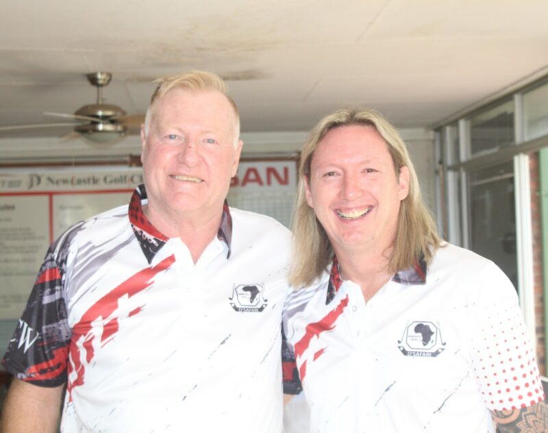Two golfers posing for a photo at the Newcastle Golf Club wearing their golfing attire.