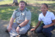 An image of Frikkie Bekker with a Lakeside learner during the leopard tortoise awareness.