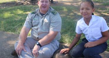 An image of Frikkie Bekker with a Lakeside learner during the leopard tortoise awareness.