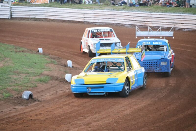 Three cars racing against each other.