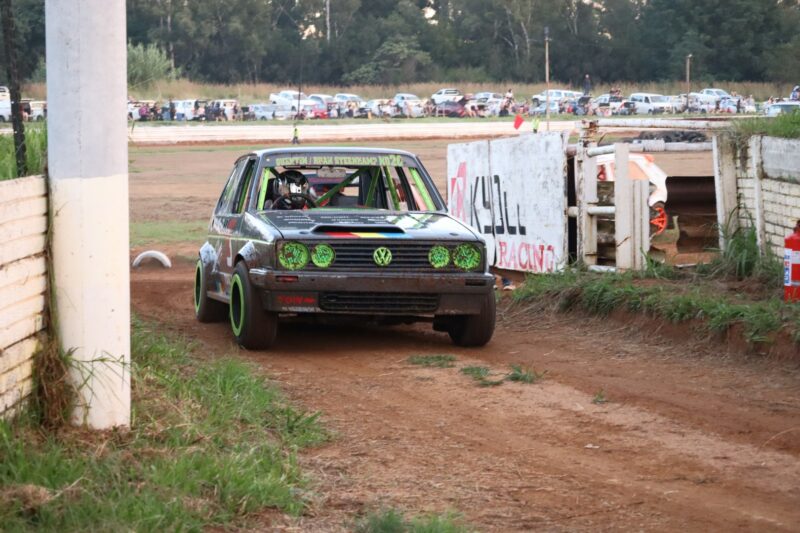 One of the drivers is driving into the drivers' pit after he has completed his racing.