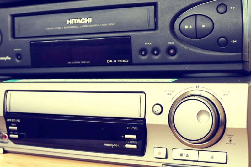 Old, VCR players stacked on top of each other.