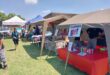 Image of stalls with local produce set up for a market.