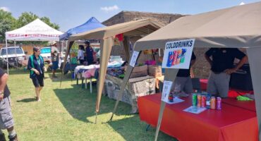 Image of stalls with local produce set up for a market.