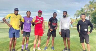 Image of six men posing on the parkrun route in athletic gear.