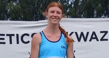 Image of a young red headed girl with blue athletic gear.