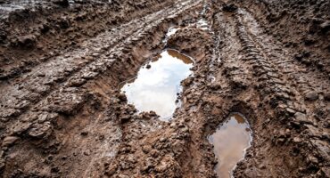 Image from Freepik of a muddy gravel road.