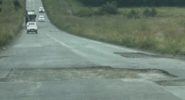 Image of dug out patches of tar on a road.