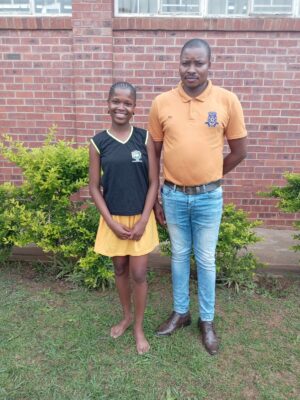 An image of Amahle Mncube, a learner from Filidi Secondary School with her coach Mndeni Shabangu. Amahle impressed in the district athletics competition.