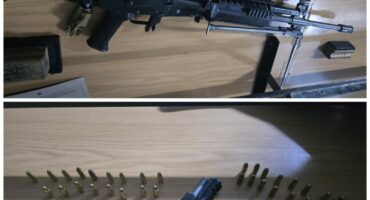 Image of a cache of illegal firearms.