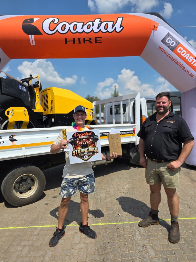 A photo of a man participating in a strong man competition at the Newcastle Coastal Hire New Store launch.