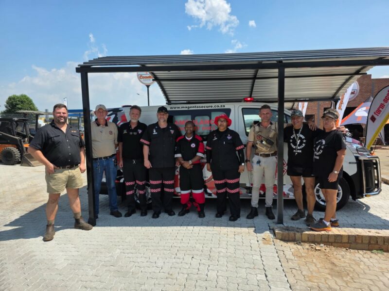A group of people standing under a carport during the Newcastle Coastal Hire new store launch.
