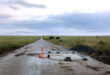 Image showing damage road surface on the R33 between Dundee and Vryheid with cones one of which is lying down.